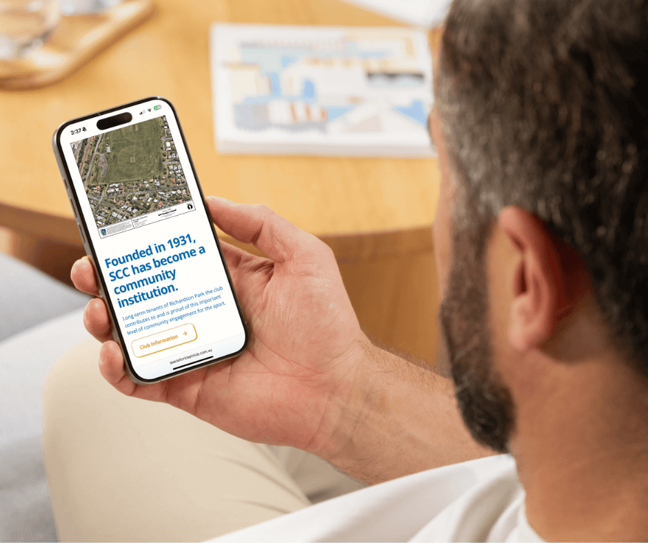Man looking at his mobile phone with the Sawtell Cricket Club 'About Us' page showing on the phone. Website Design by Lemon Street