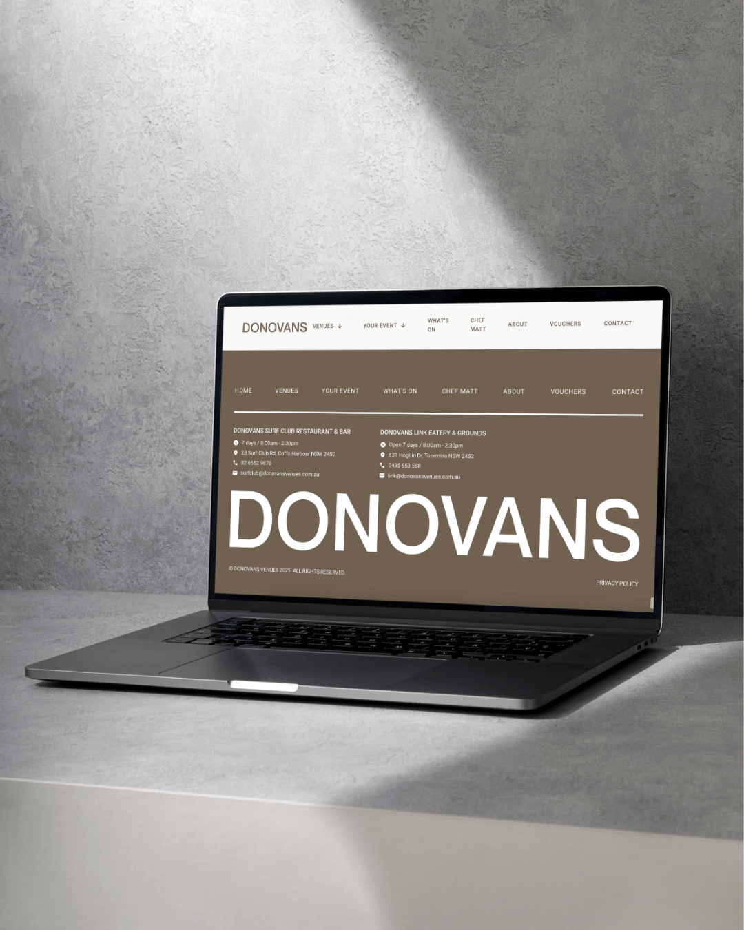 Donovan's Venues footer on a laptop screen on a grey background. Website Design by Lemon Street