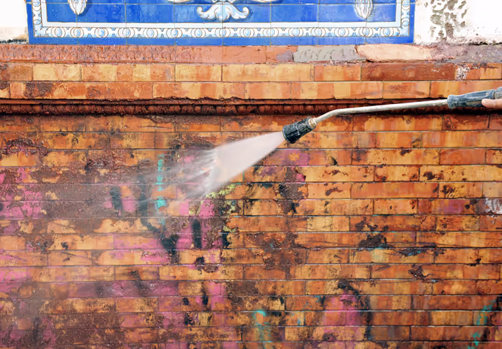 Graffiti removal from an exterior brick wall at a commercial property in Box Hill.