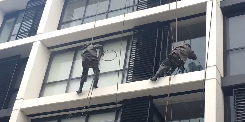 Rope access team cleaning windows