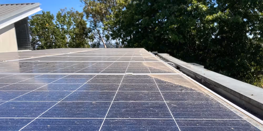 Dirty solar panels covered in dust and debris before solar panel cleaning.