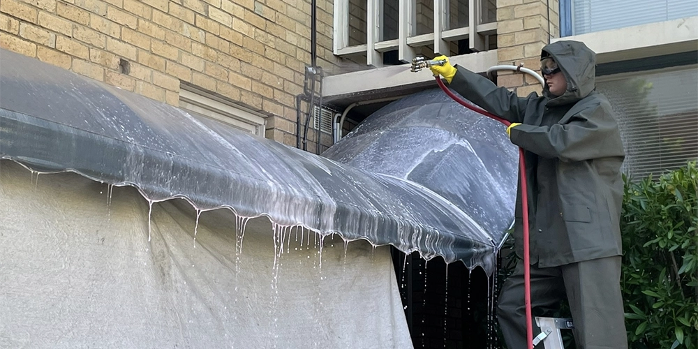 Cleaning awnings on apartment block entrance