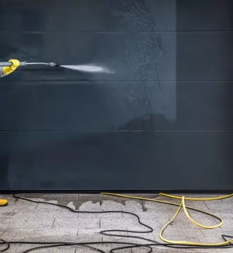 High-pressure washing used to clear surface marks from a dark exterior wall in Chadstone.