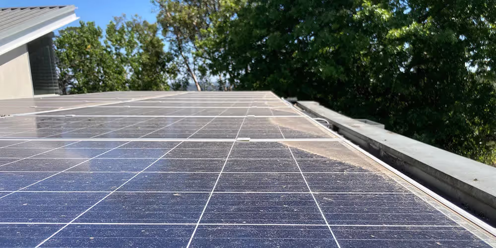 Solar panels on a South Melbourne rooftop coated in salt residue and urban grime before cleaning.