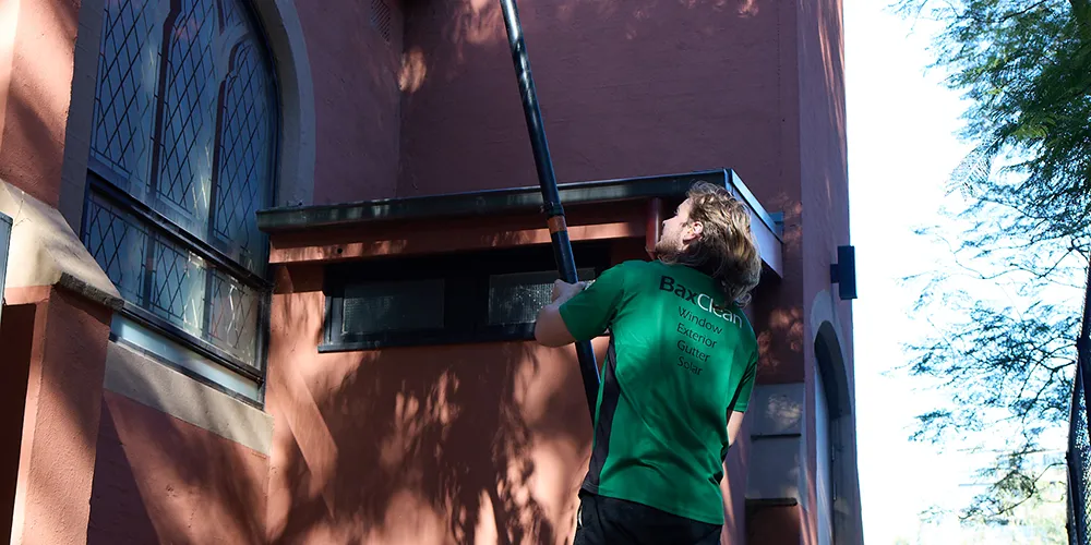 Cheltenham gutter cleaning specialist cleaning roofline and gutter system.