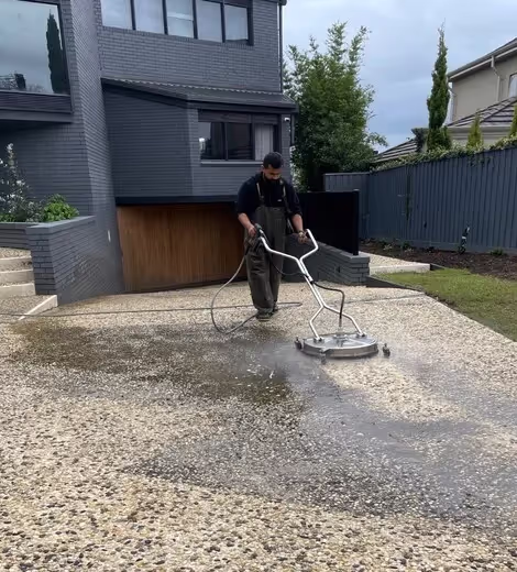 Professional pressure cleaning service washing concrete driveway in Cheltenham.