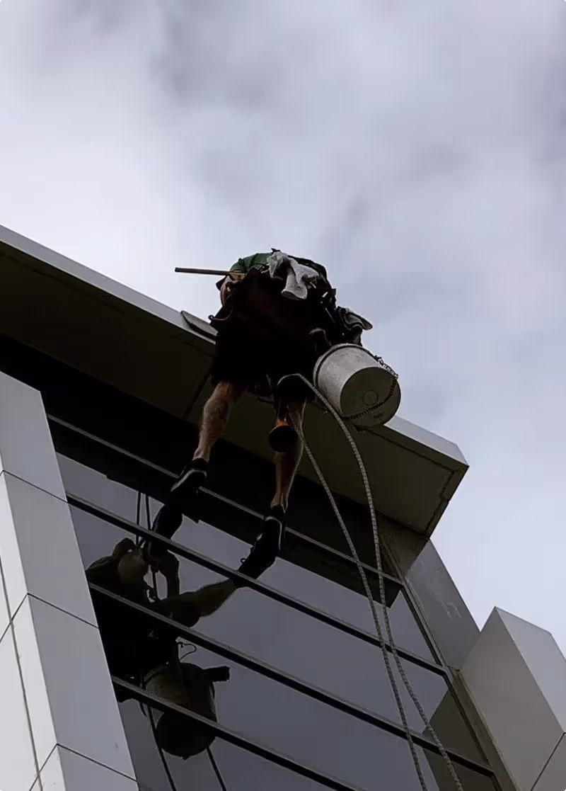Three of our Bax Clean specialists safely rappelling down the side of a building.