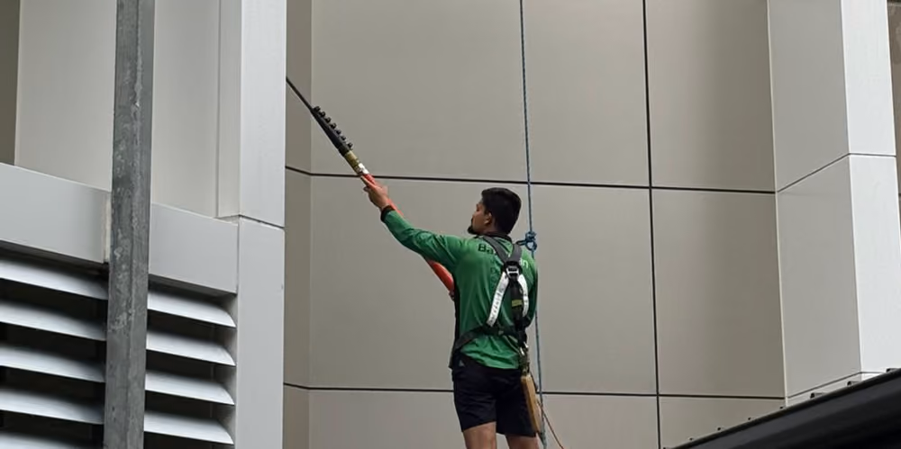 BaxClean technician performing exterior window cleaning at an aged care facility using professional safety equipment.
