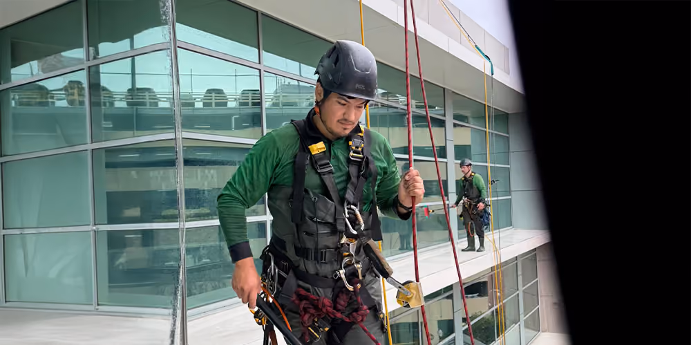 Professional rope access window cleaner maintaining exterior glass at an aged care facility.