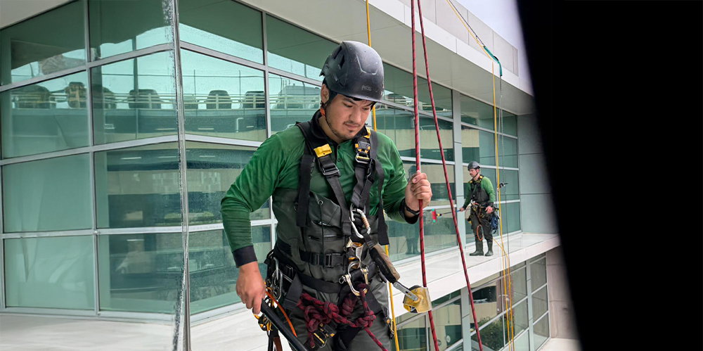 Professional rope access window cleaner maintaining exterior glass at an aged care facility.