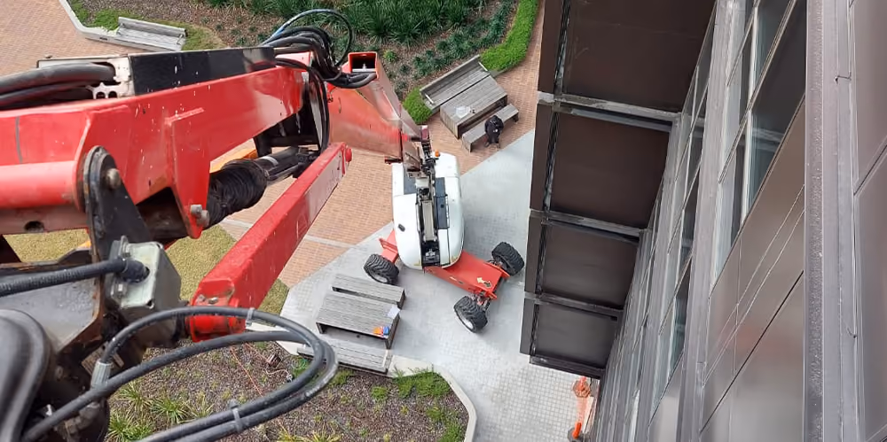 View from an elevated work platform overlooking the courtyard during high-access building maintenance.