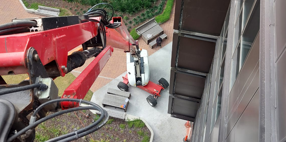 View from an elevated work platform overlooking the courtyard during high-access building maintenance.