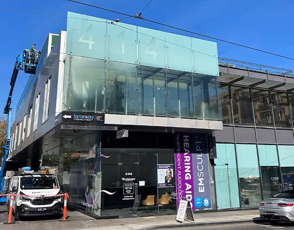 Before and after comparison of commercial window cleaning by Bax Clean