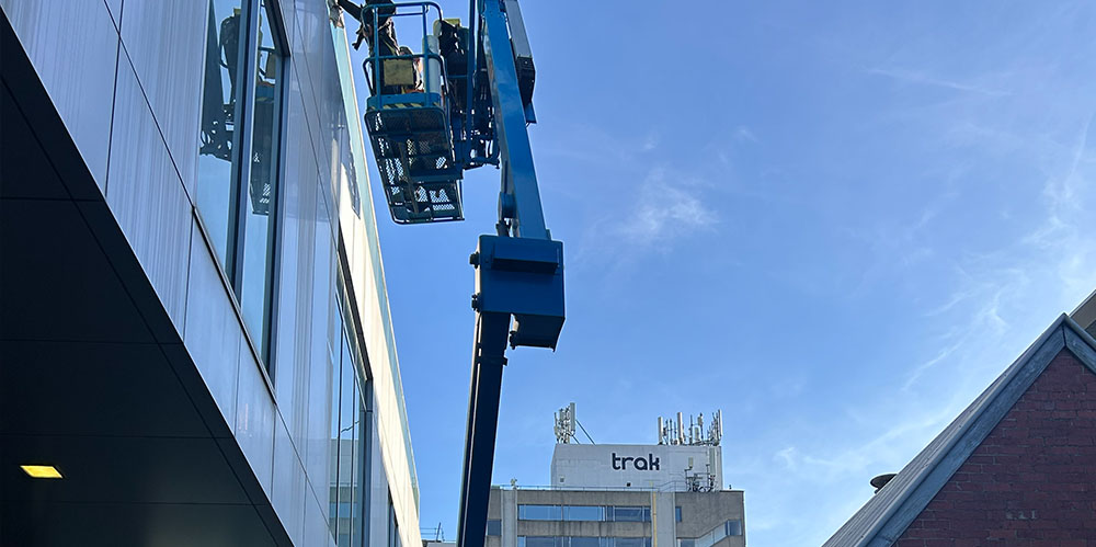 Elevated work platform providing safe access for exterior window cleaning on a multi-storey commercial building.
