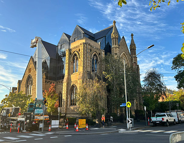 Historic Gothic church building seamlessly integrated with a contemporary glass extension, showcasing heritage restoration, modern architecture, and premium exterior glazing.