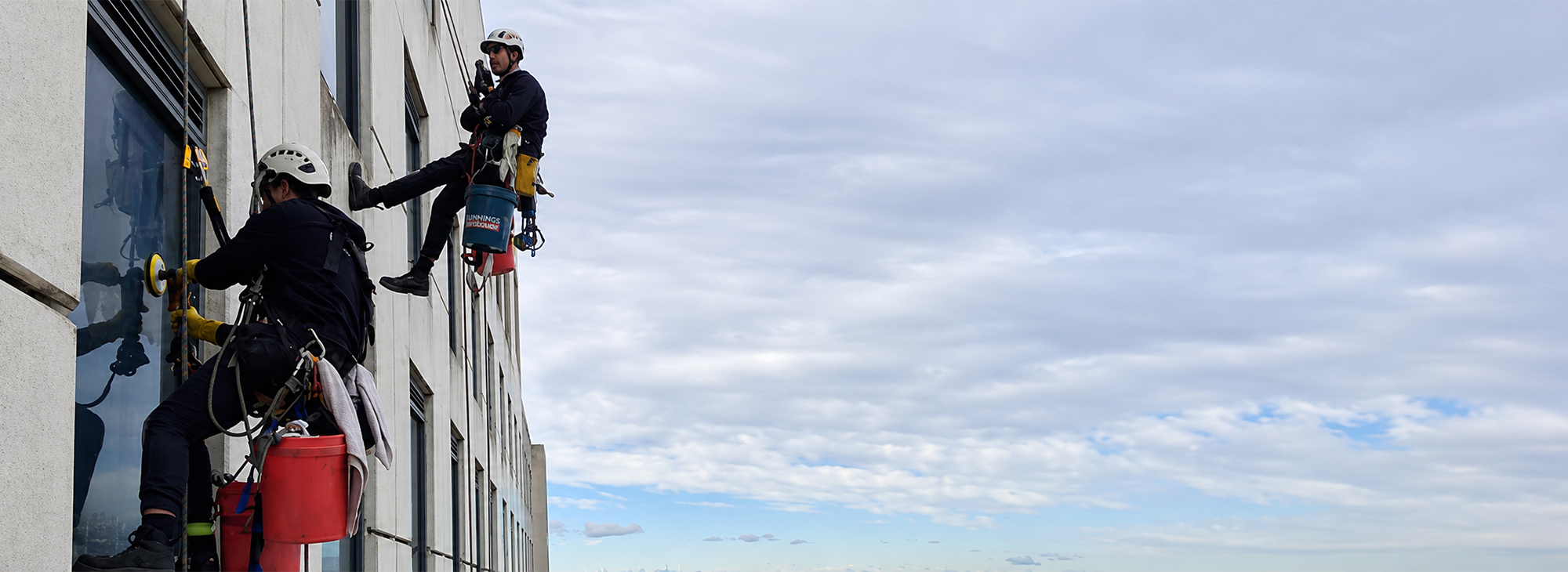 Rope access technicians cleaning the exterior windows of the Mantra Hotel Tullamarine.