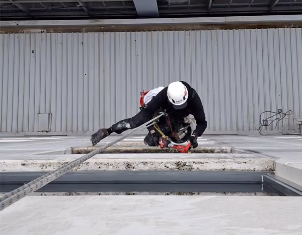Bax Clean technician using rope access to clean high-rise windows