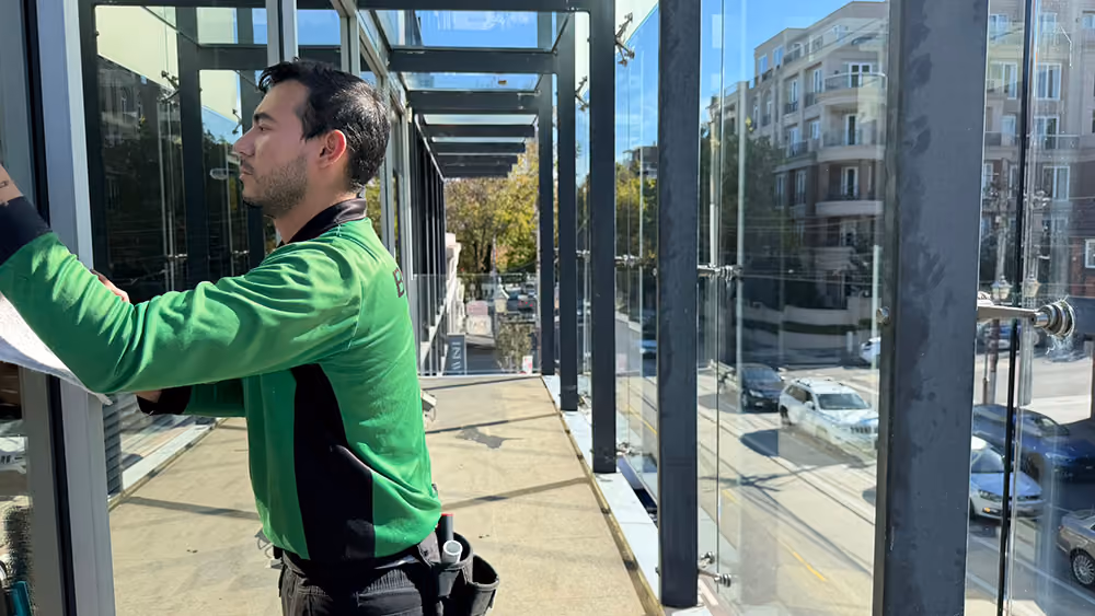 Bax Clean technician cleaning commercial windows