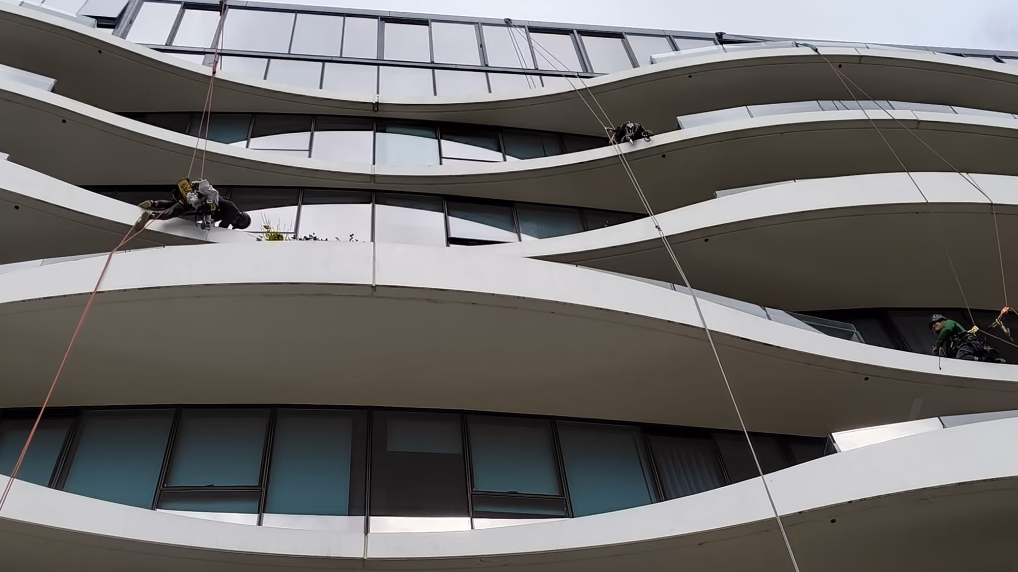 Bax Clean rope access technicians working on the exterior of a multi-storey building