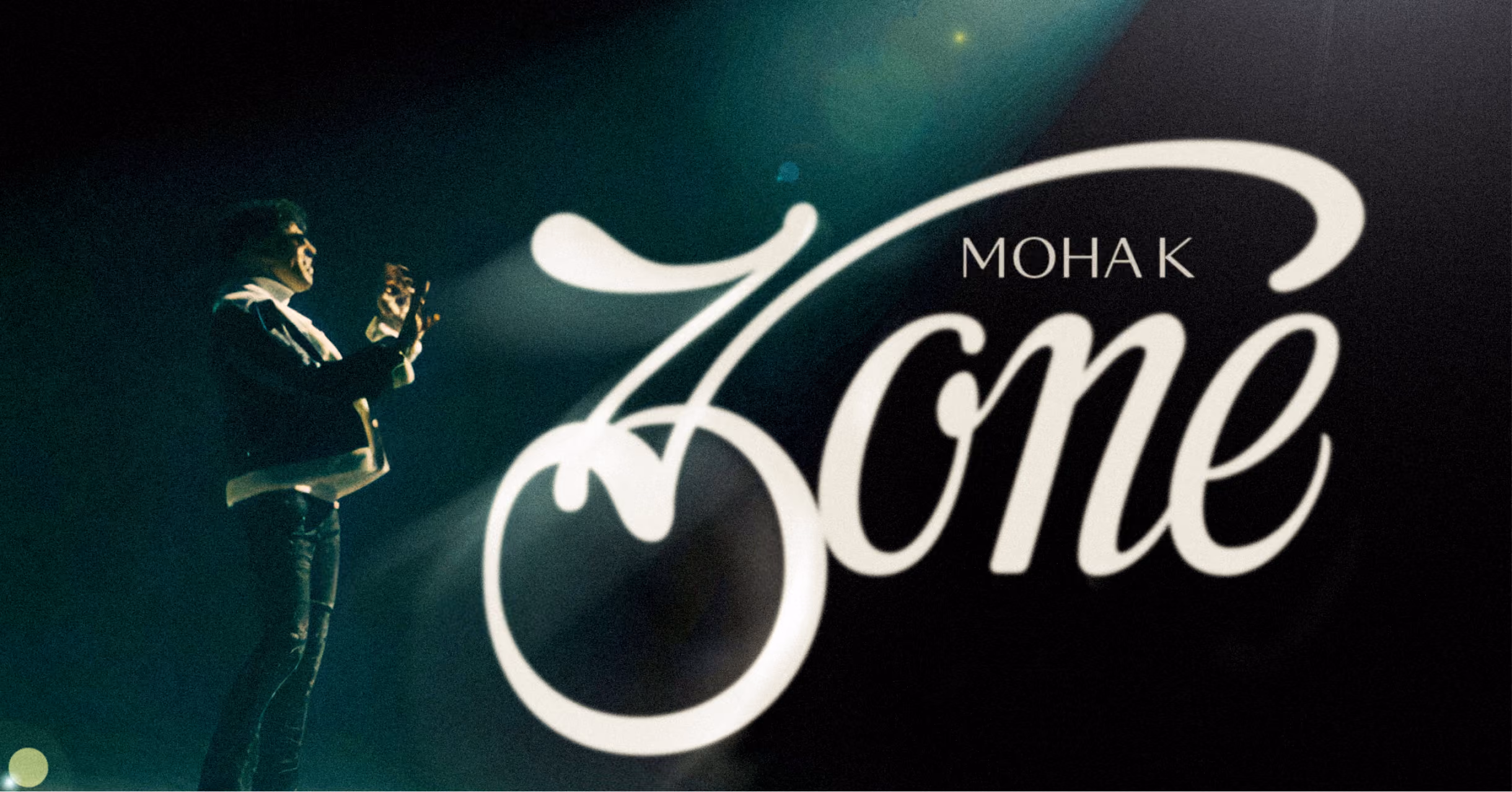 Zoné album cover for Moha K: script lettering beside a performer on a dark stage