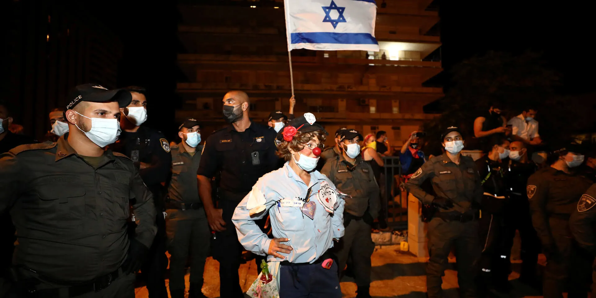 A woman in a clown-police officer costume during a demonstration in Jerusalem. Photo: Reuters