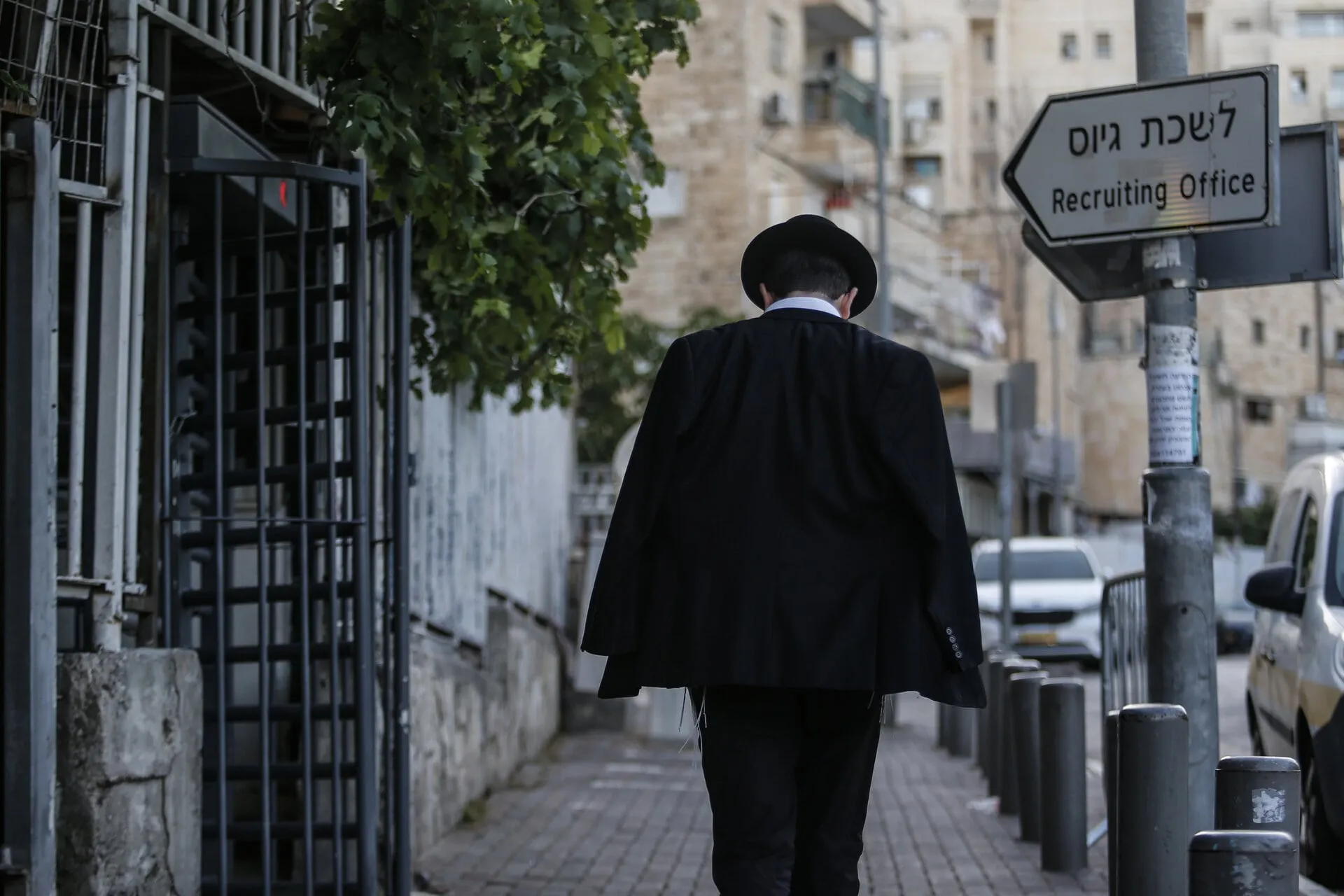 An ultra-Orthodox man walks past the recruiting office in Jerusalem. Photo: Reuters