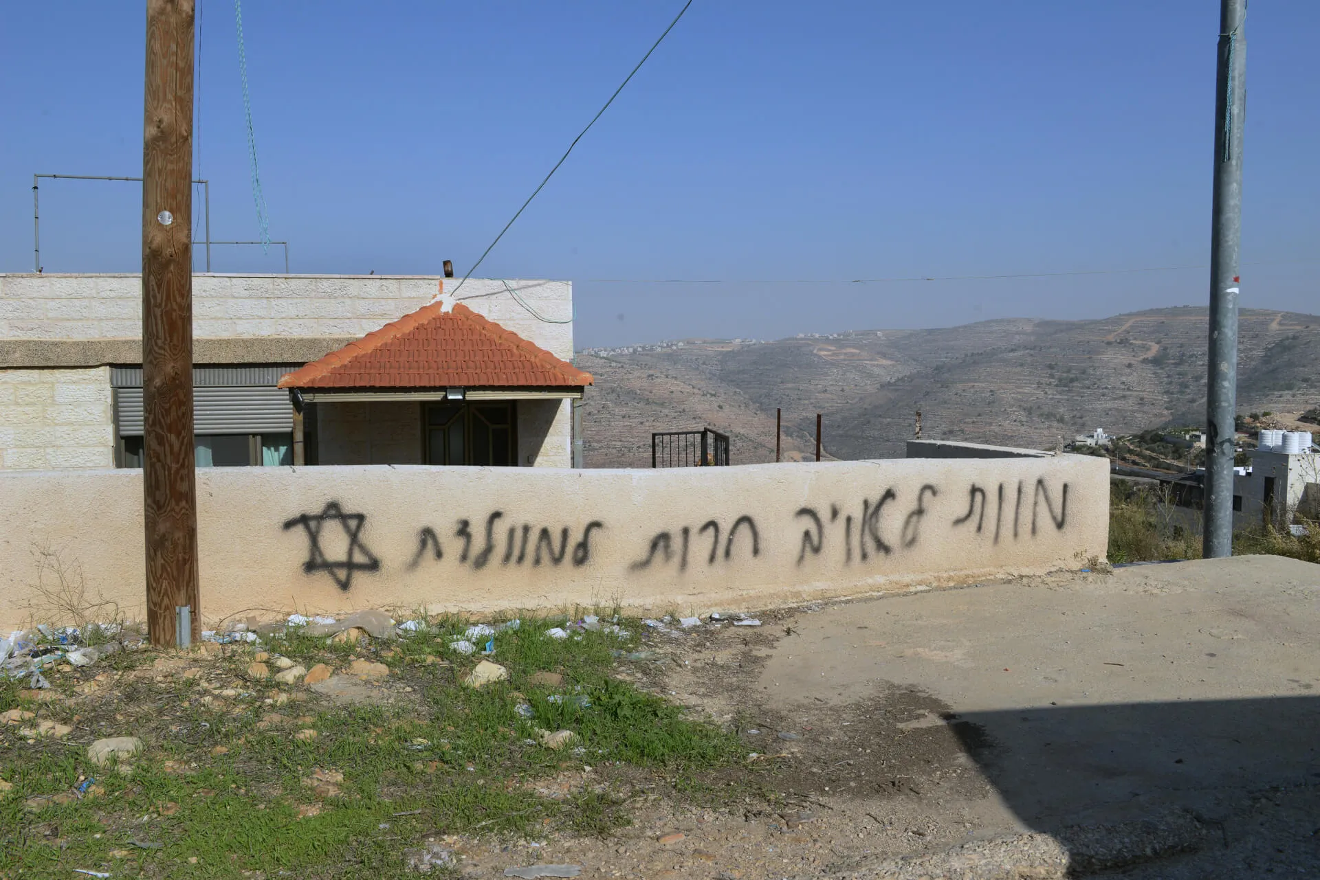 "Death to the enemy, freedom to the homeland." A graffiti sprayed on a house in the Palestinian village of Atarah, December 2025. Photo: Eyal Izhar