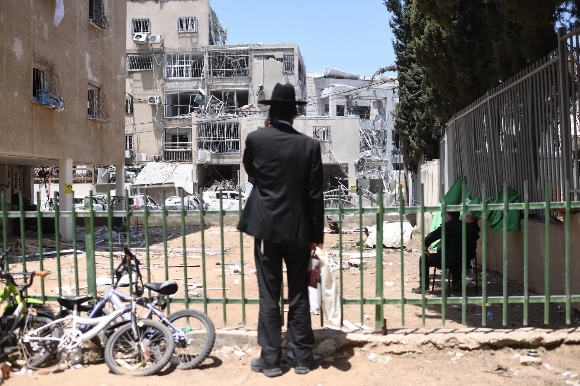 A man looks at the scene of a missile strike in Bnei Brak, June 2025. Photo: Reuters