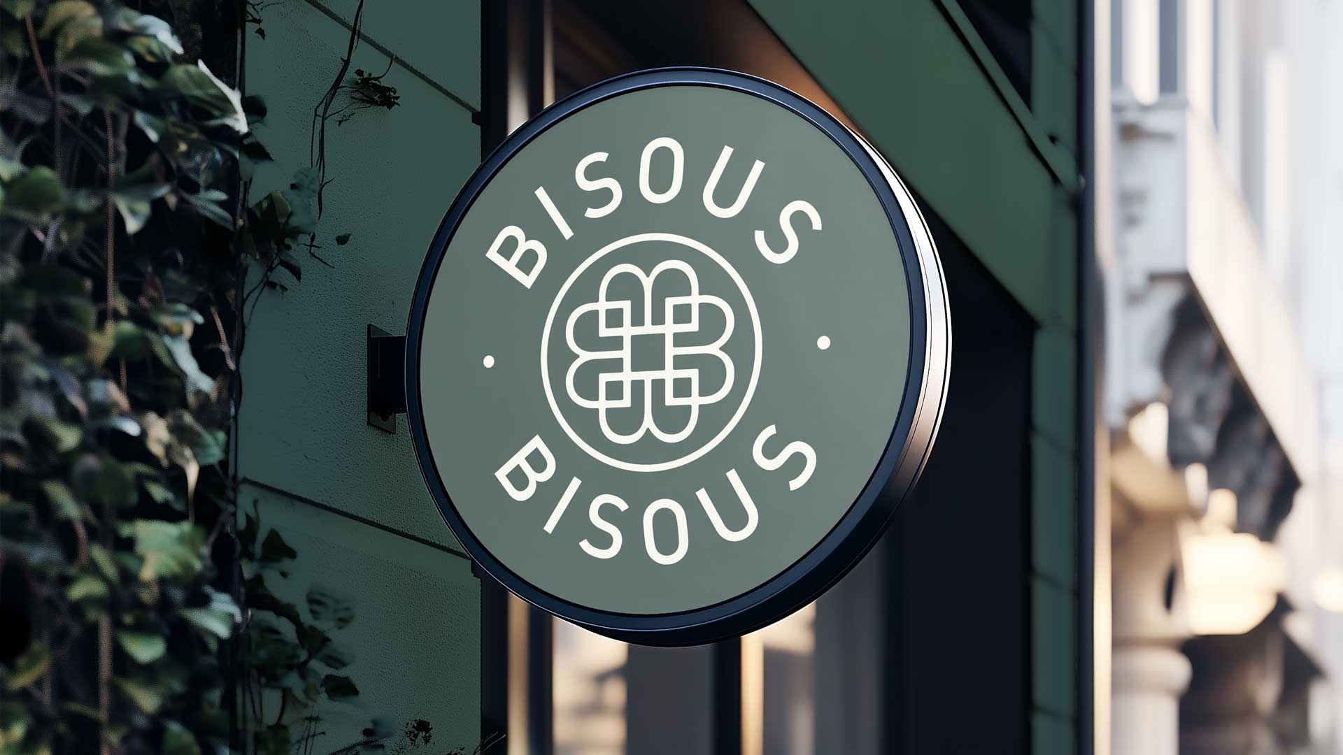 Circular Bisous Bisous projecting shop sign