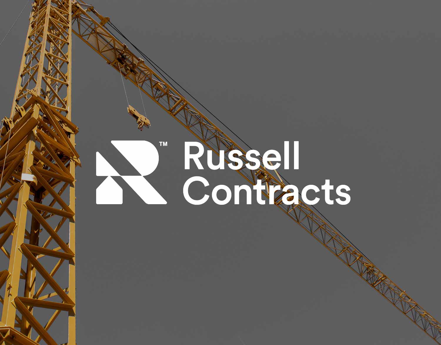 Russell Contracts logo displayed over a construction site with yellow tower cranes.