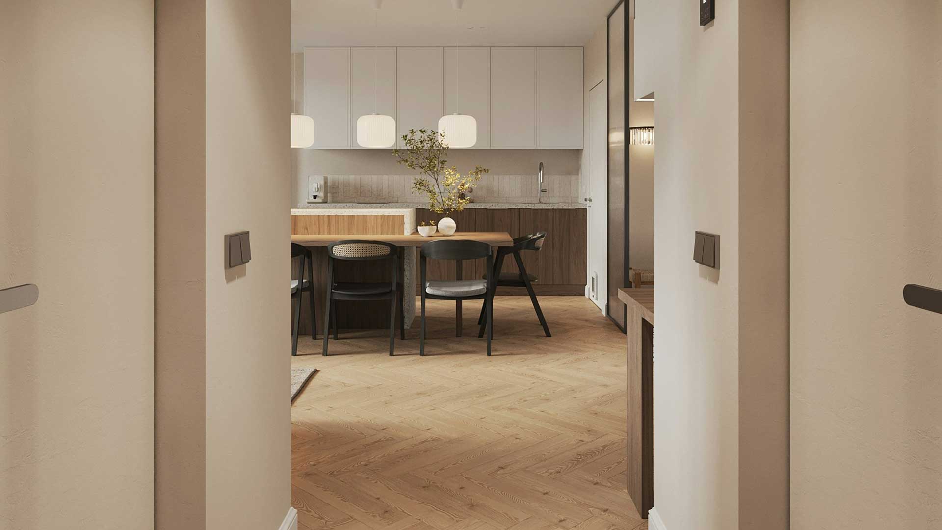 View through a doorway into a pale timber kitchen and dining area with herringbone flooring and pendant lights.