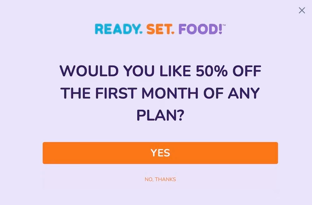 The first step in Ready. Set. Food!'s welcome popup asks "Would you like 50% off the first month of any plan?" It has a big orange "YES" button and a small link that says, "No, thanks."