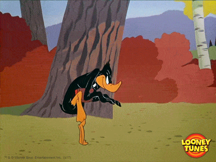 Daffy Duck sneaking around in the woods.