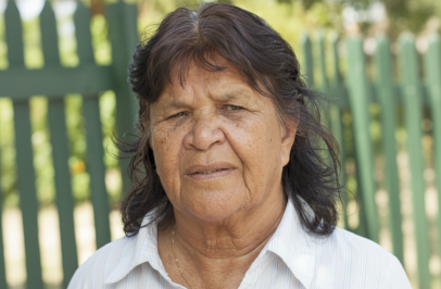 Portrait of Dorothy from shoulders up wearing a white shirt and looking at the camera