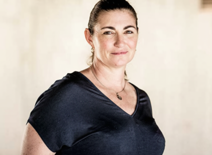 Portrait of Karen wearing a dark shirt looking at the camera