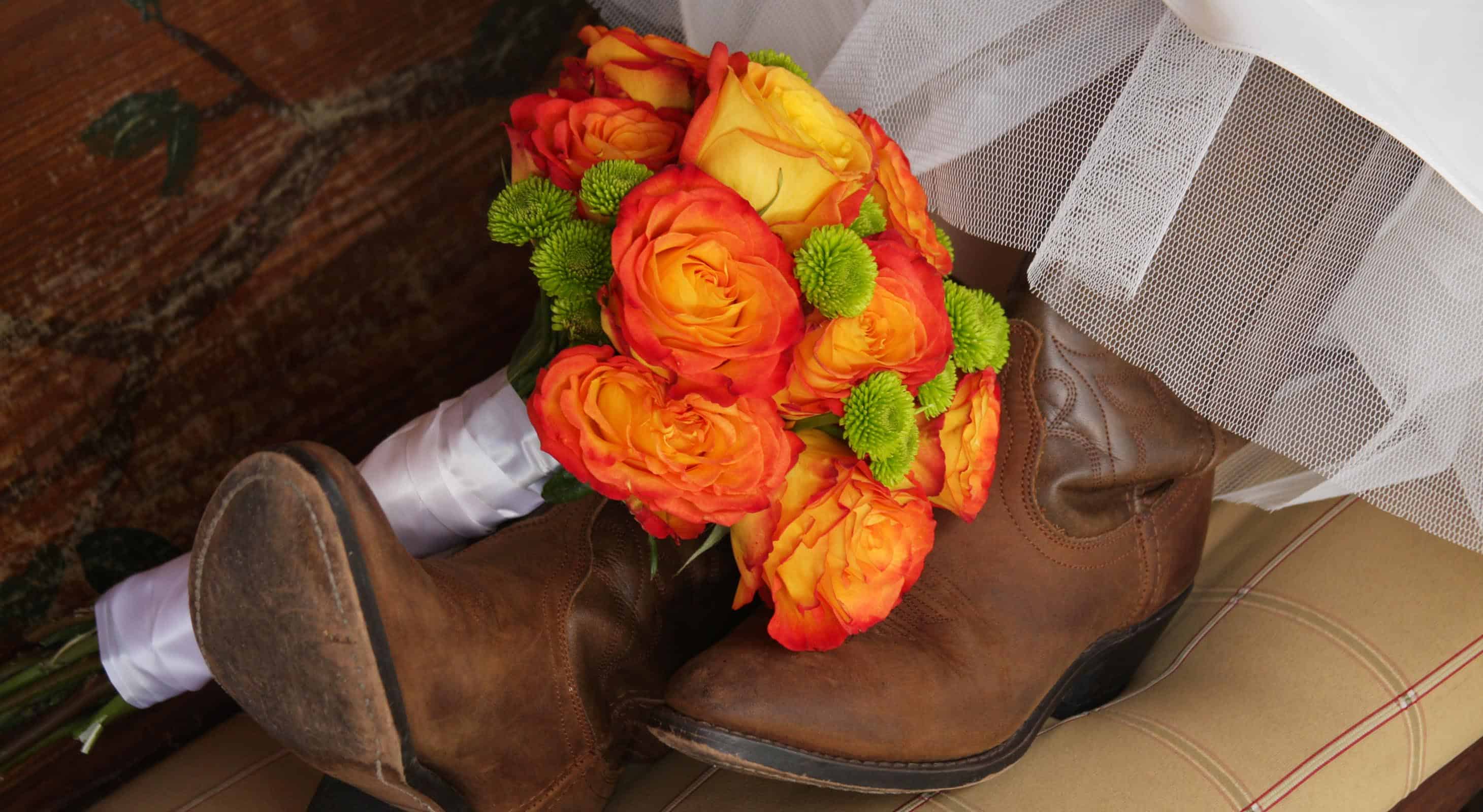 a bouquet of flowers and cowboy boots