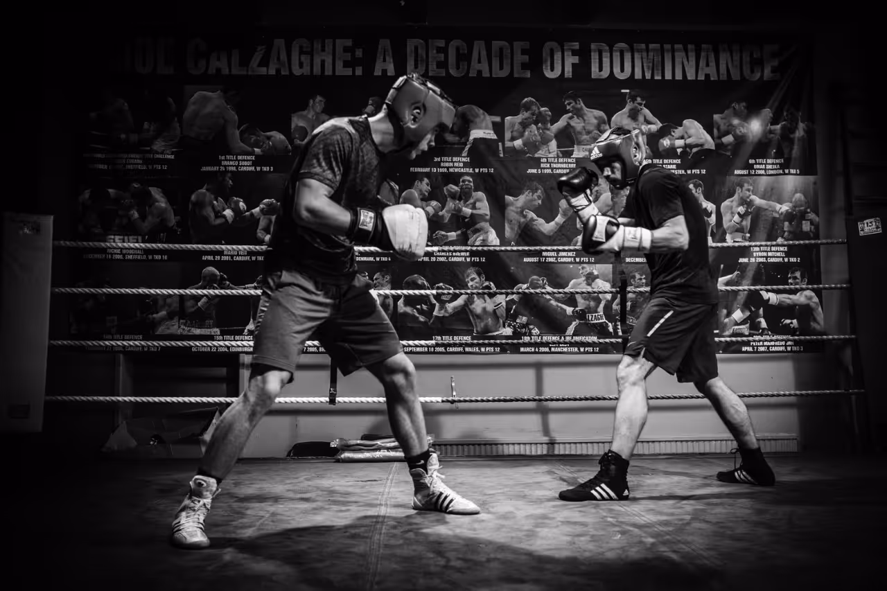 a man punching another man in a boxing ring