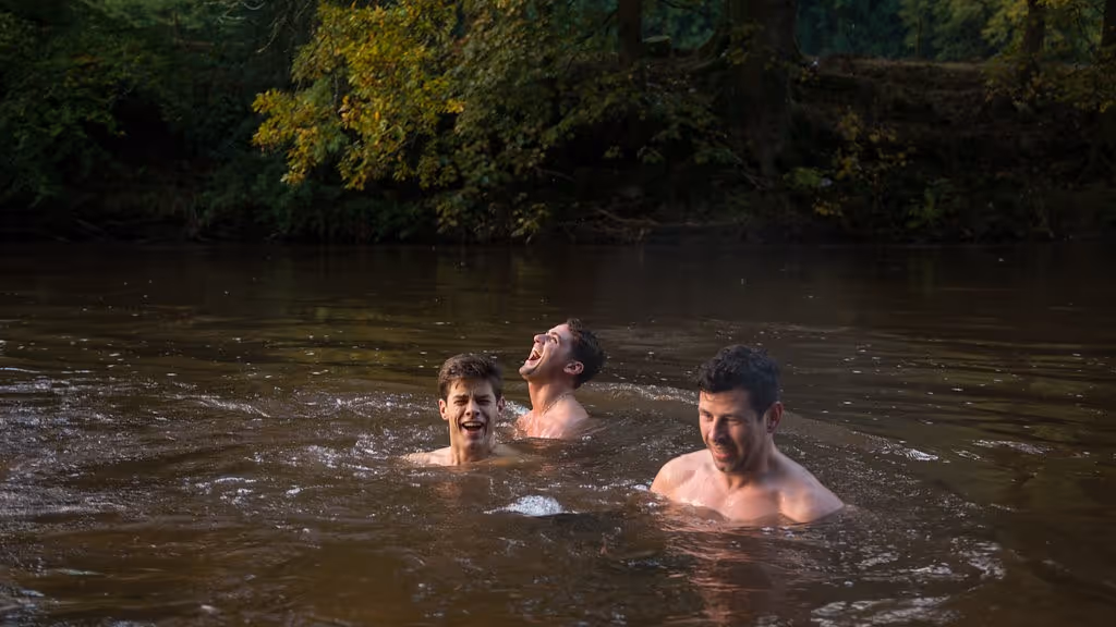 a group of men in a river