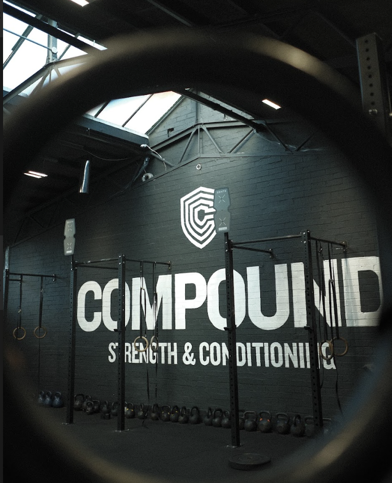 People training with kettlebells in gym