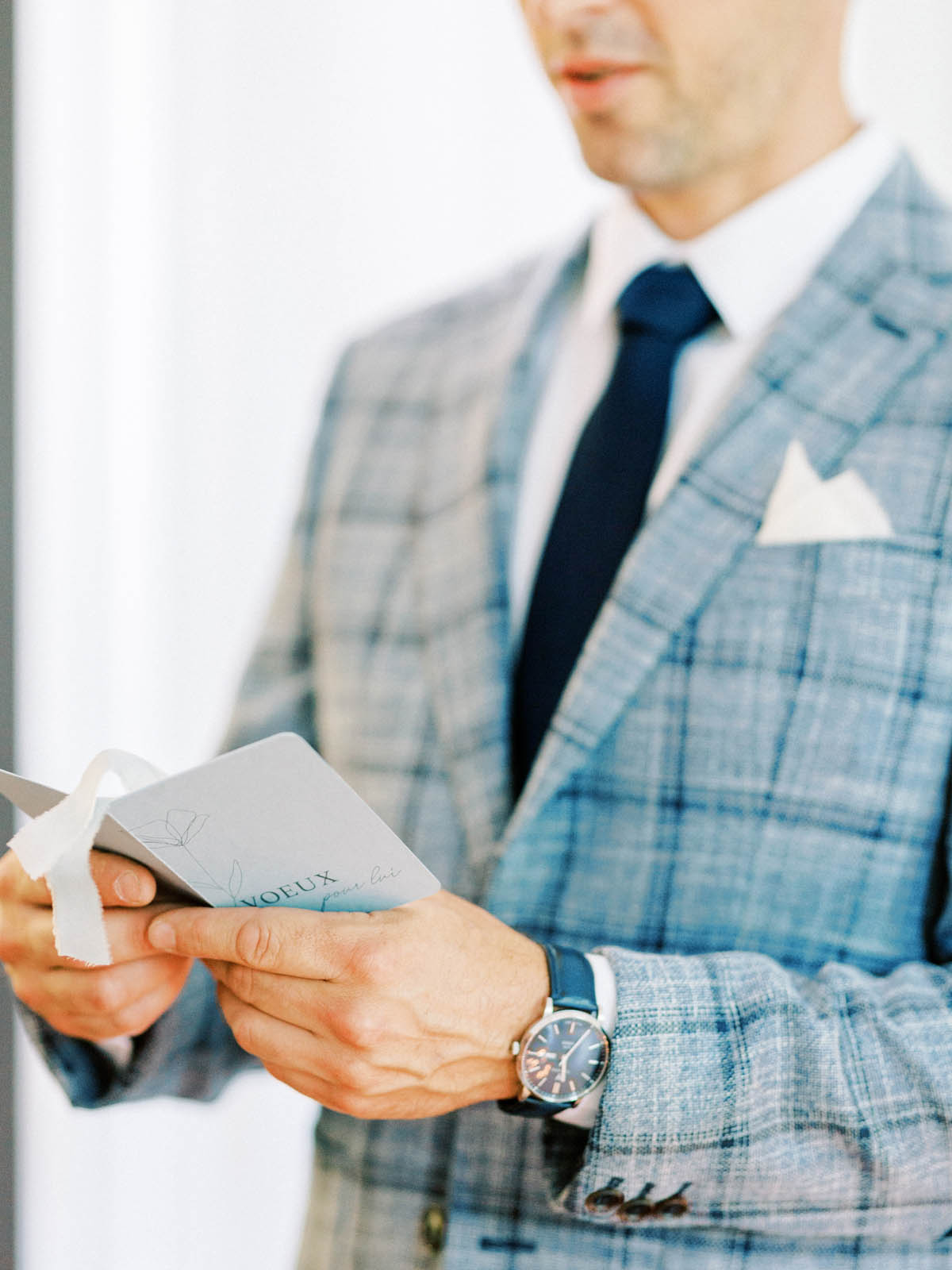 Groom reading his vow booklet before the ceremony