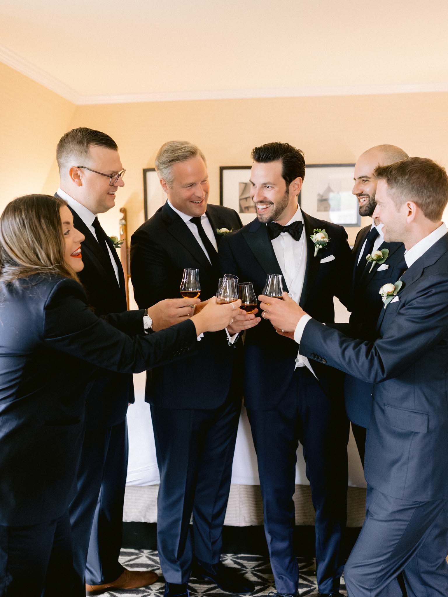 Groom and his wedding party toasting with whisky before the ceremony