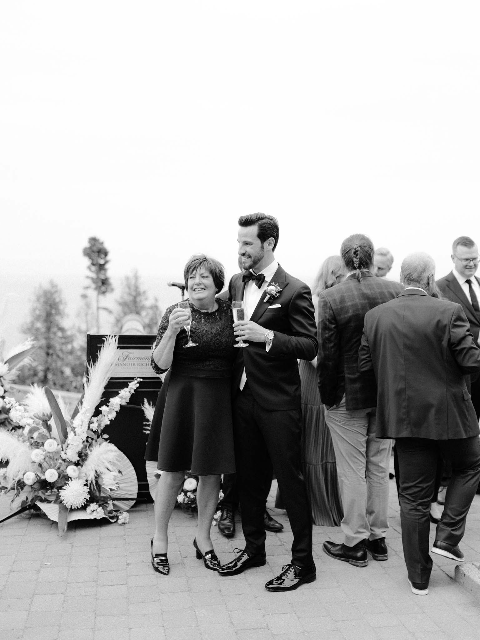 Groom toasting with his mother among the guests after the ceremony