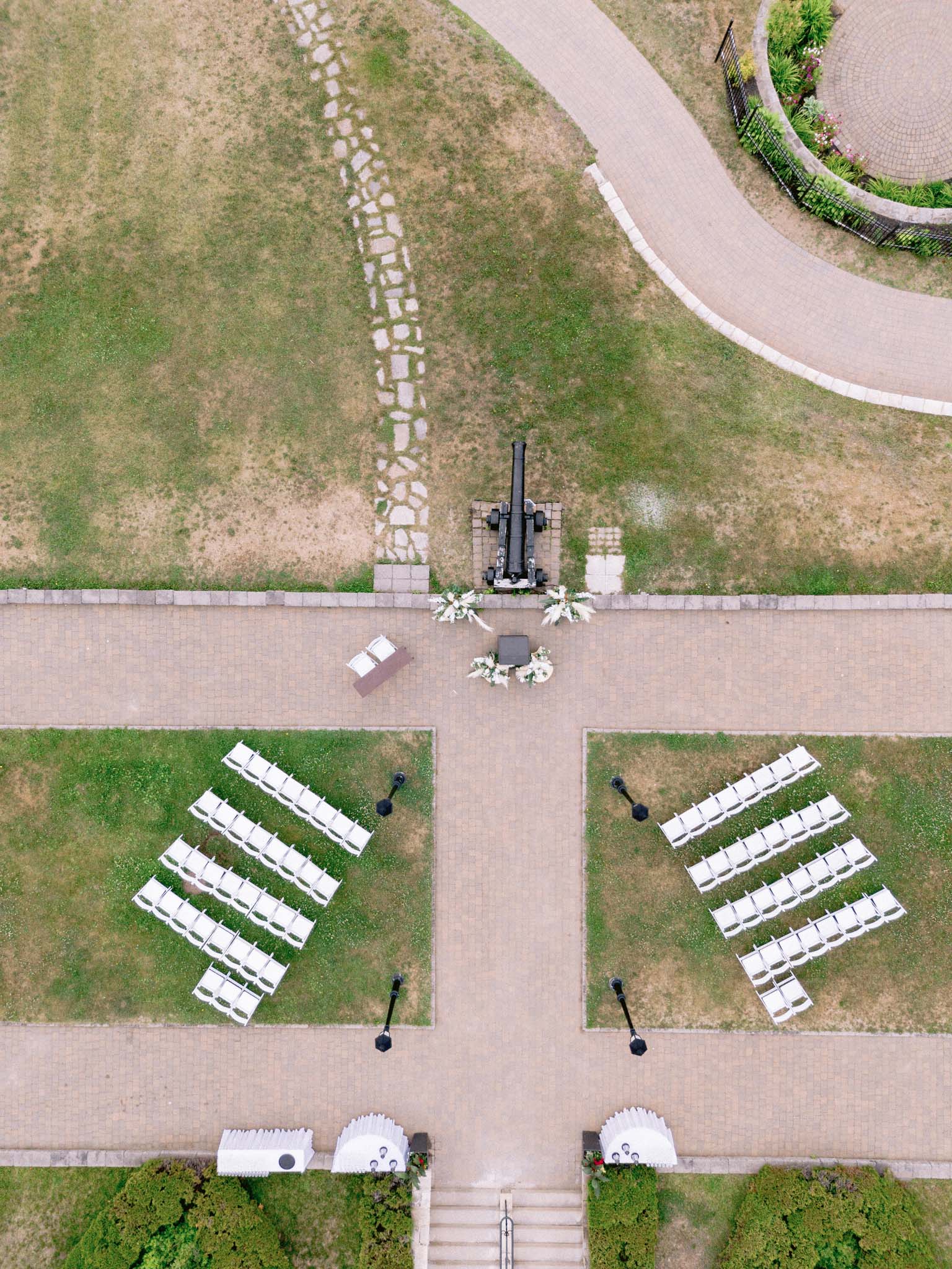 Aerial view of the outdoor ceremony chairs set out on the lawn either side of the cannon