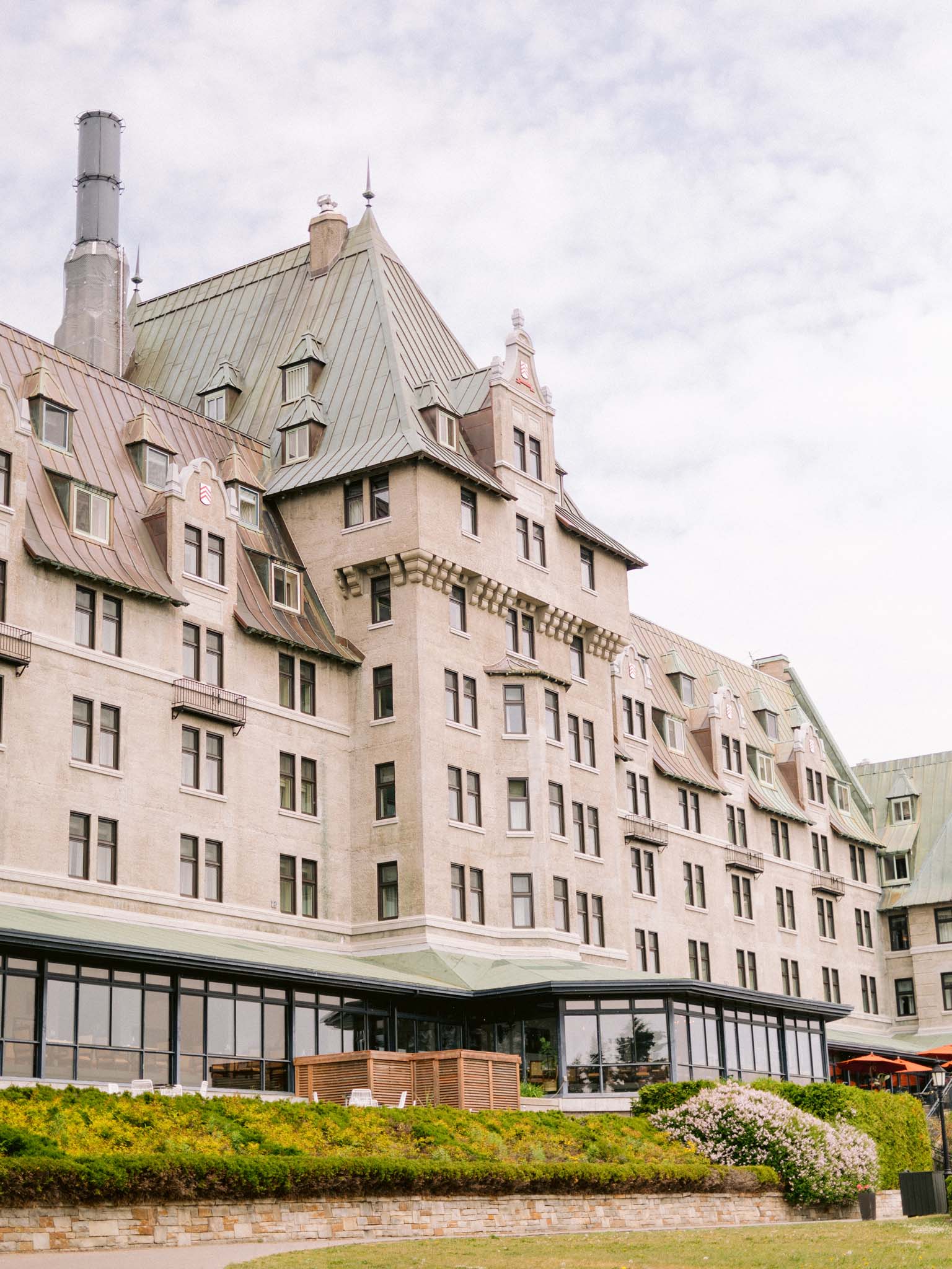 The stone facade and green copper roof of Fairmont Le Manoir Richelieu in Charlevoix