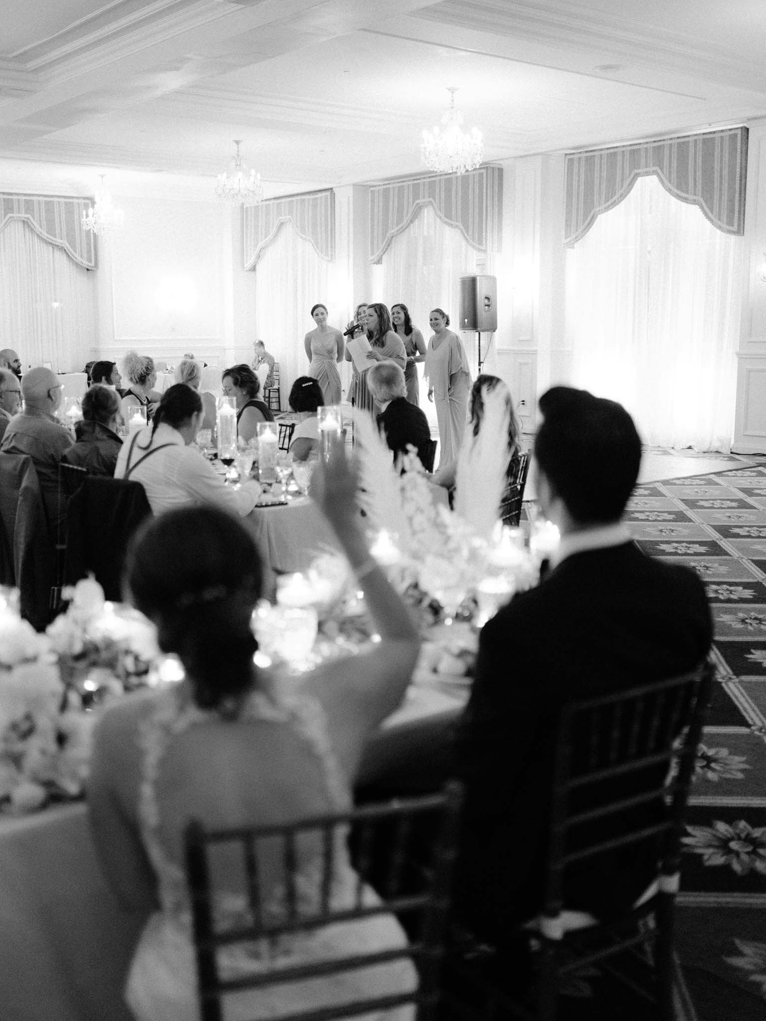 The bridesmaids giving a speech together at the microphone