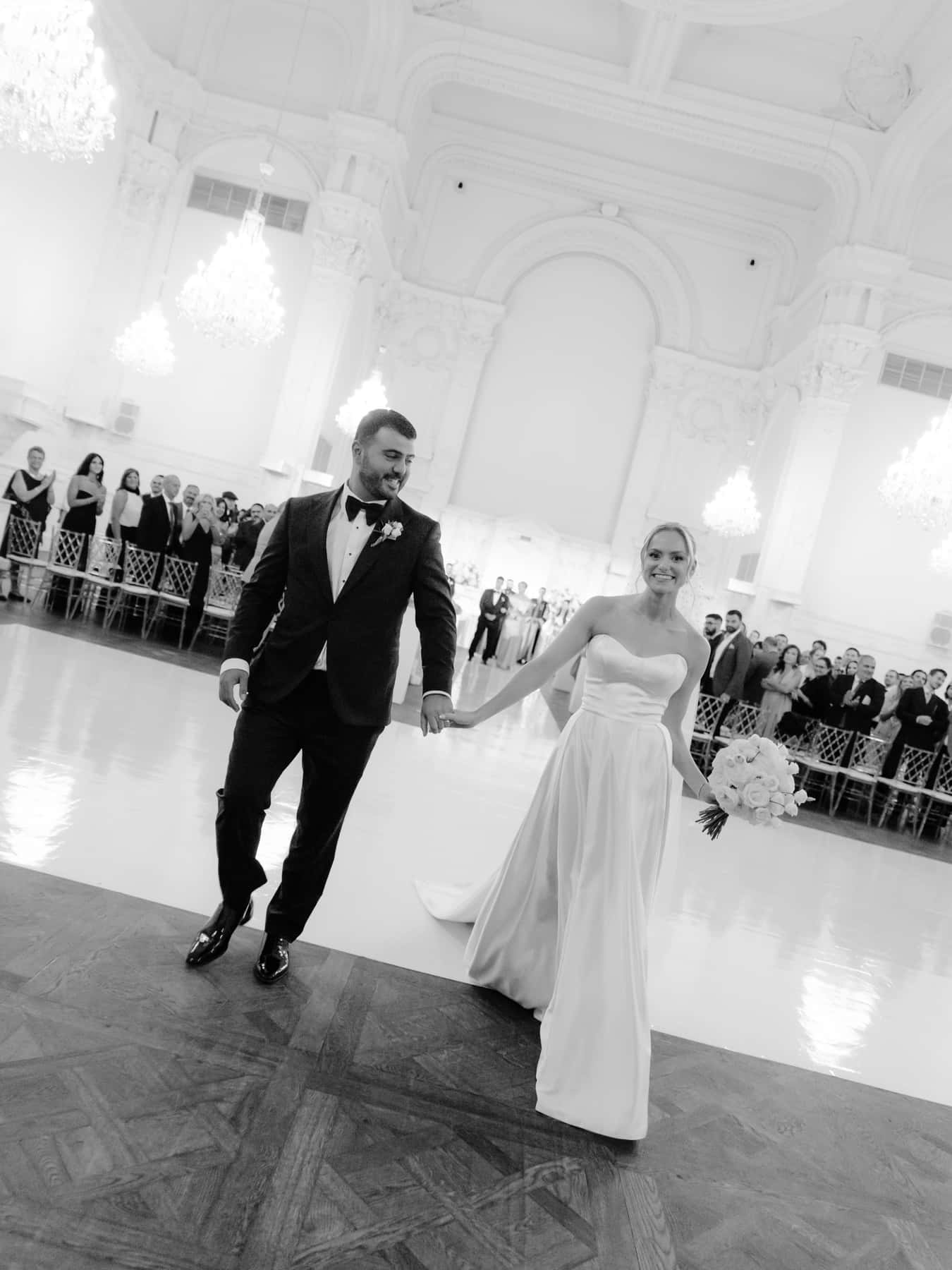Bride and groom walking back up the aisle after their ceremony