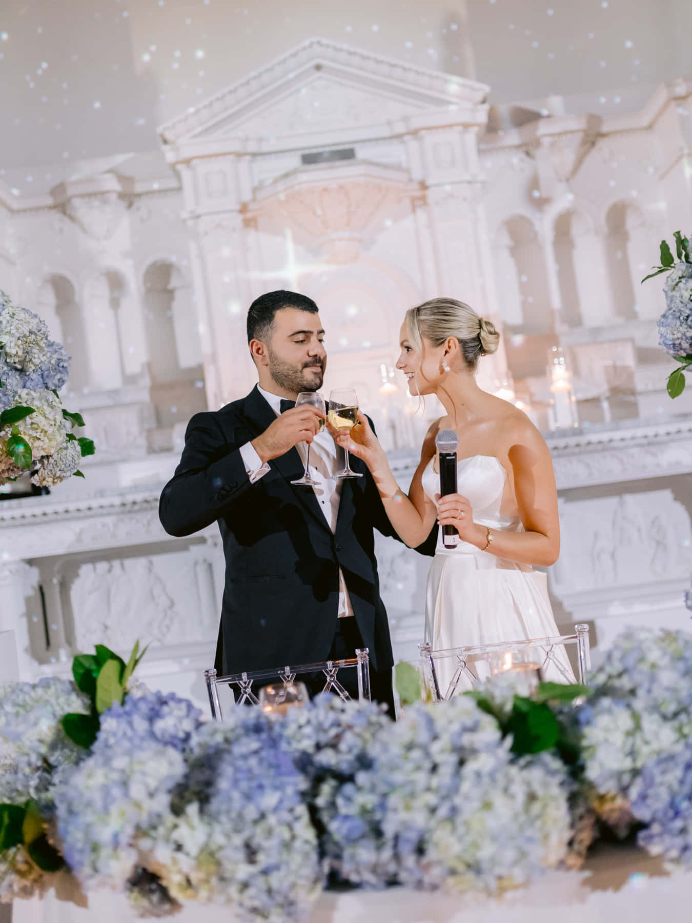 Bride and groom raising a toast at the head table