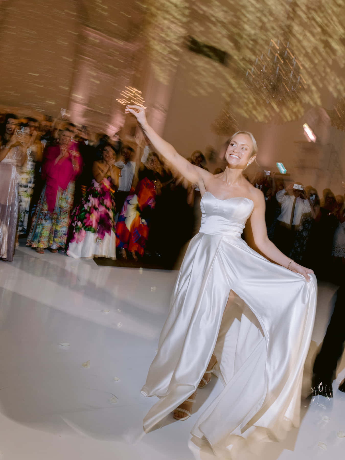 Bride and groom dancing as guests circle the dance floor