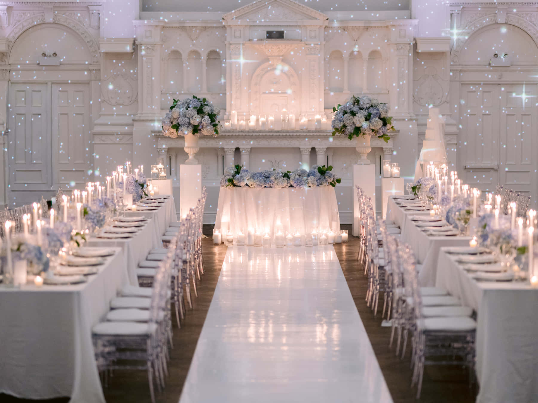 Long candlelit tables leading to the head table in the Grand Salon