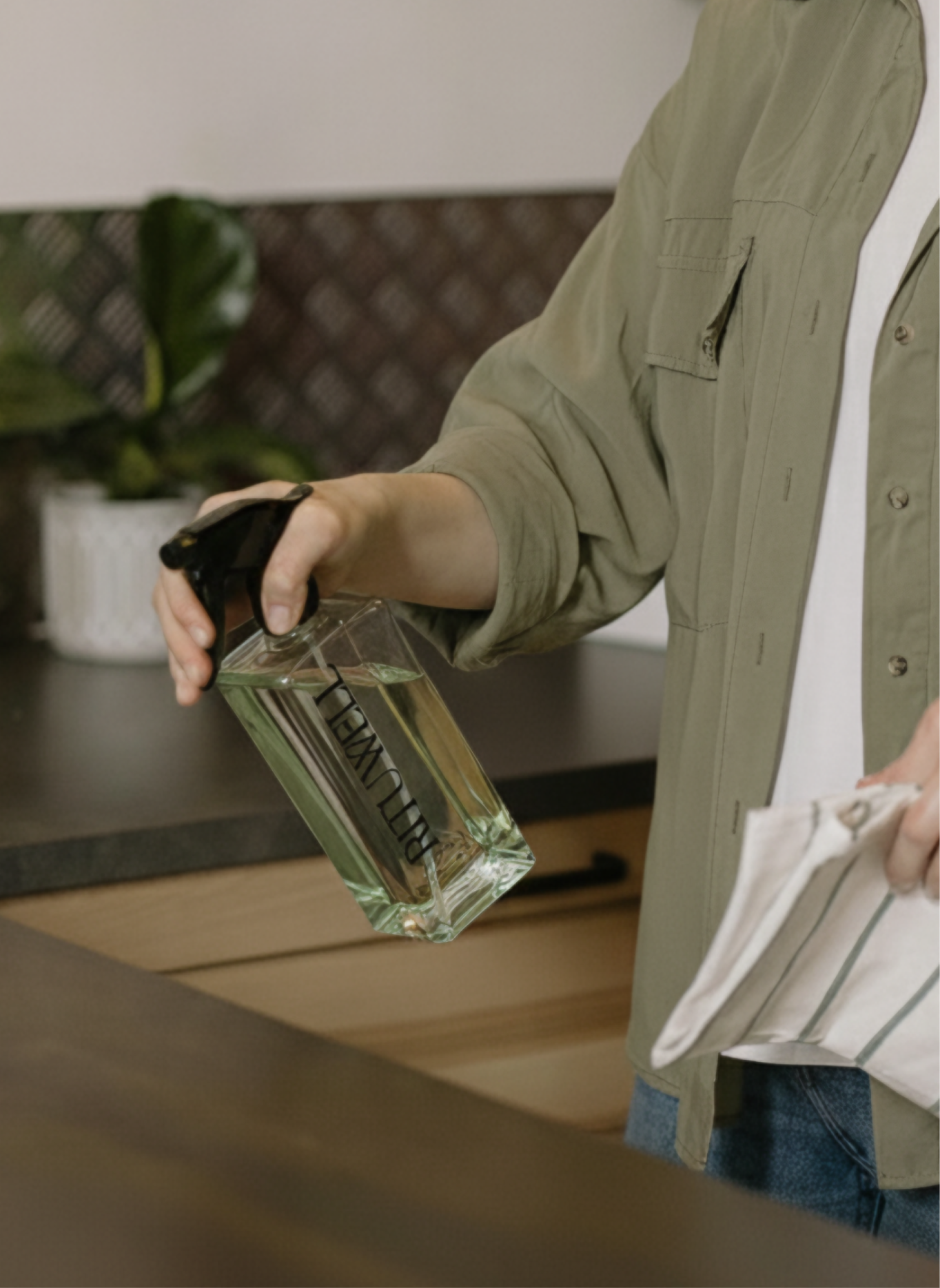 Poster with a woman sitting in front of a dark backdrop with KNTR logos coloured in different skin tone colours 